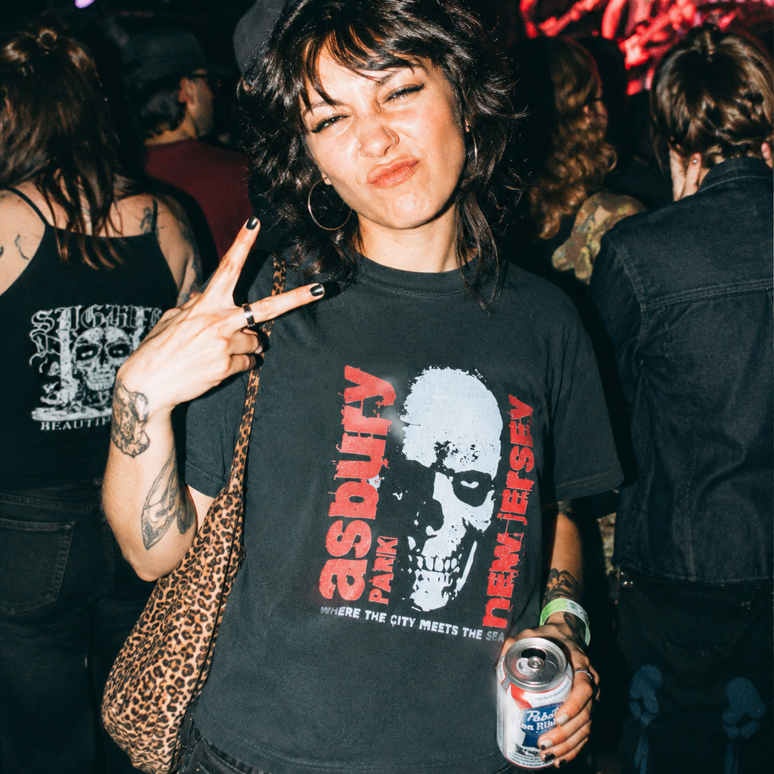 Friends out at night wearing Promised Land graphic tees